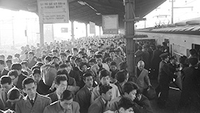 Tokyo commuters walk through a packed railway station.