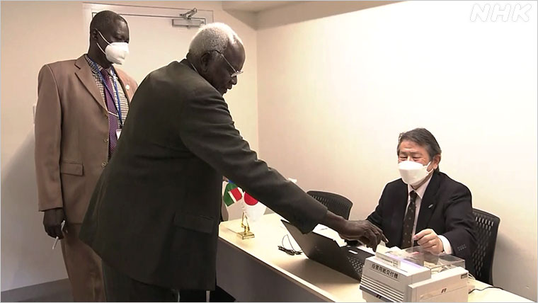 自動交付機から投票用紙を受け取る南スーダンの研修員