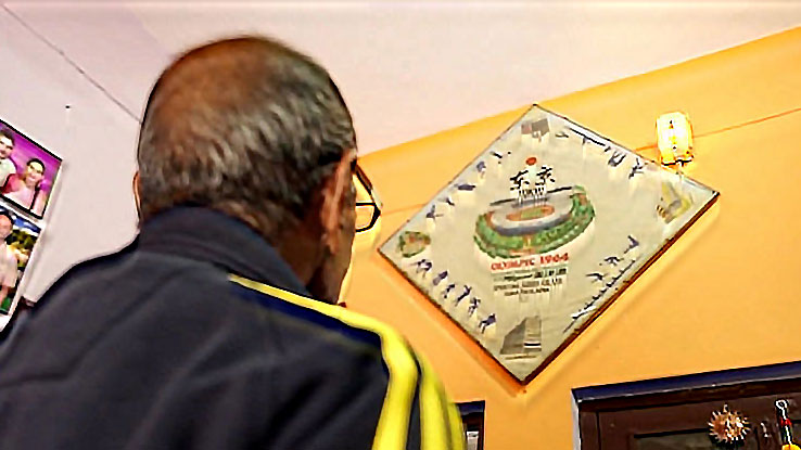 Singh looking at Olympic banner
