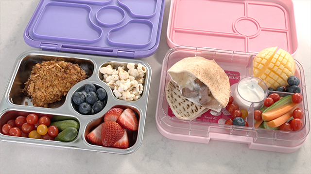 He adds a sliced mango, popcorn, and colorful fruits and vegetables to complete his creative bentos.